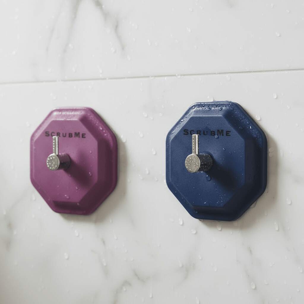 Modern bathroom tile wall with a minimalist self-adhesive hook holding a silicone shower tool, bright natural light, clean and premium look.