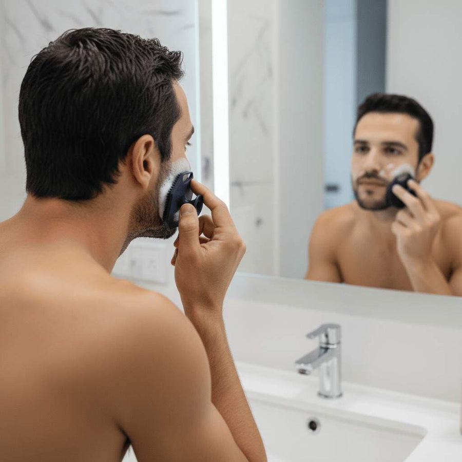 Person using a silicone face scrubber gently as part of a facial cleansing routine.