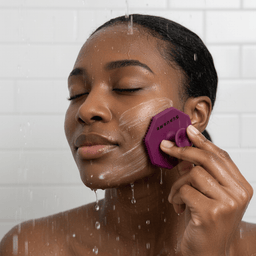 Black woman in shower with foam using Passionate Purple ScrubMeFace