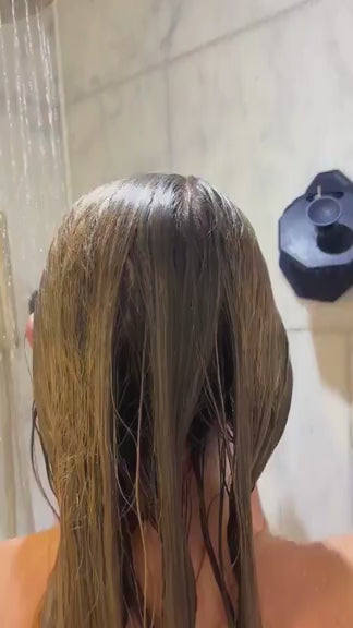 Lifestyle video of a woman massaging shampoo through her hair with the ScrubMeScalp Passionate Purple silicone scalp massager for healthier scalp and hair growth.