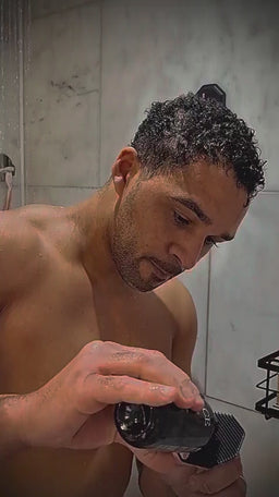 Lifestyle shower video of a man cleansing his face with the ScrubMeFace Breathtaking Blue silicone face scrubber.