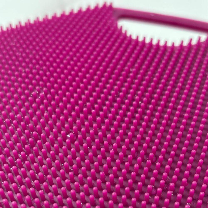 Close up macro of ScrubMeBody Passionate Purple silicone bristles showing dense fine-tip exfoliating texture.