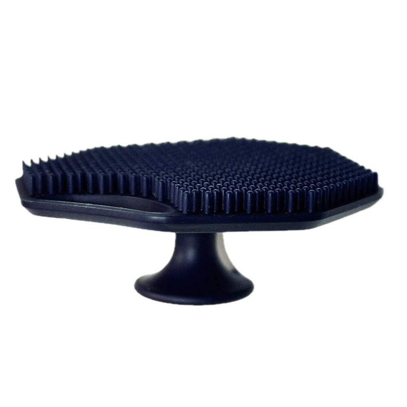 Side profile of the ScrubMeFace Breathtaking Blue silicone face scrubber showing soft cleansing bristles and suction cup base.